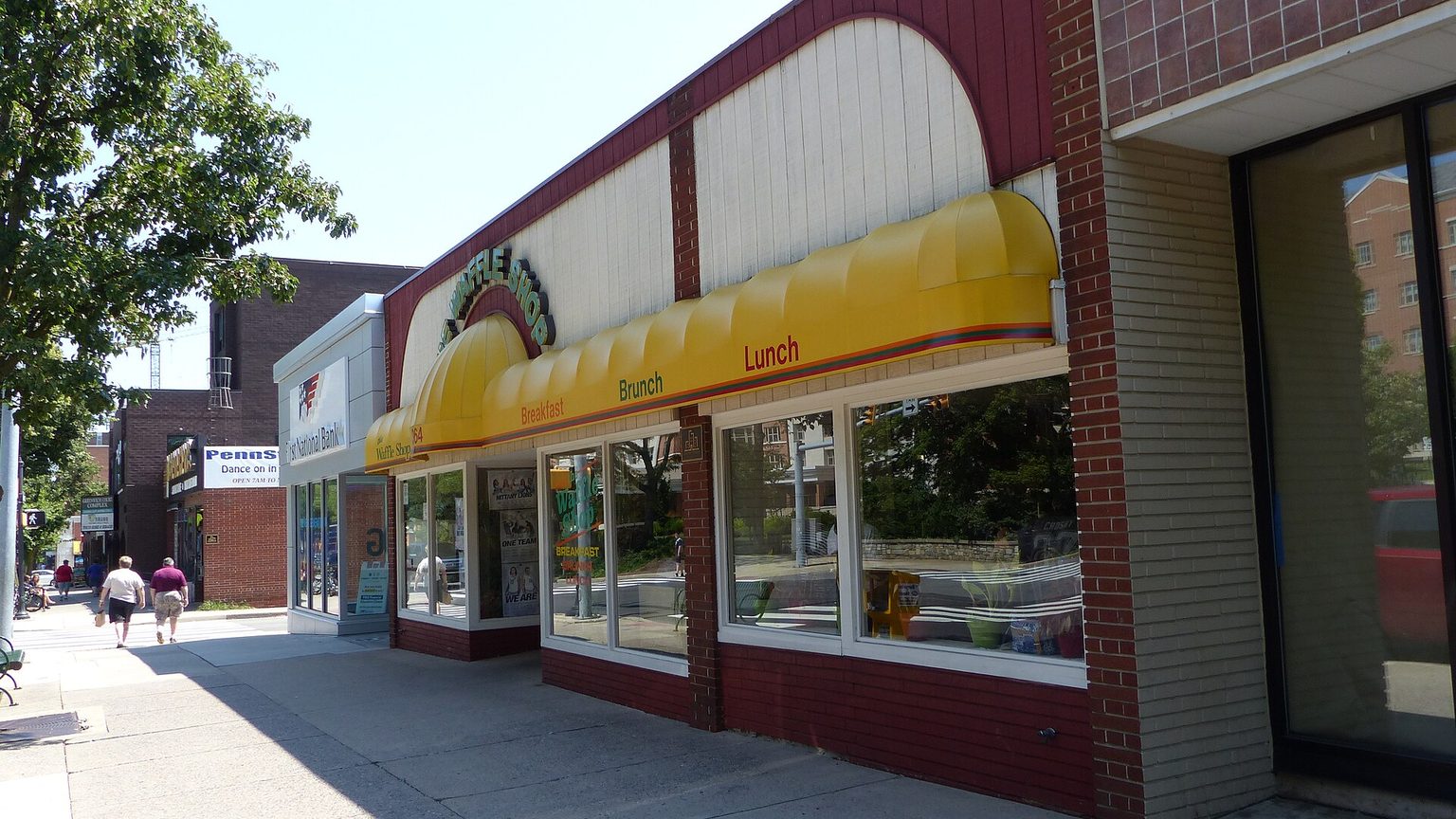 Storefronts along a downtown State College, Pennsylvania street near Penn State, where students shop for everyday essentials within walking distance.