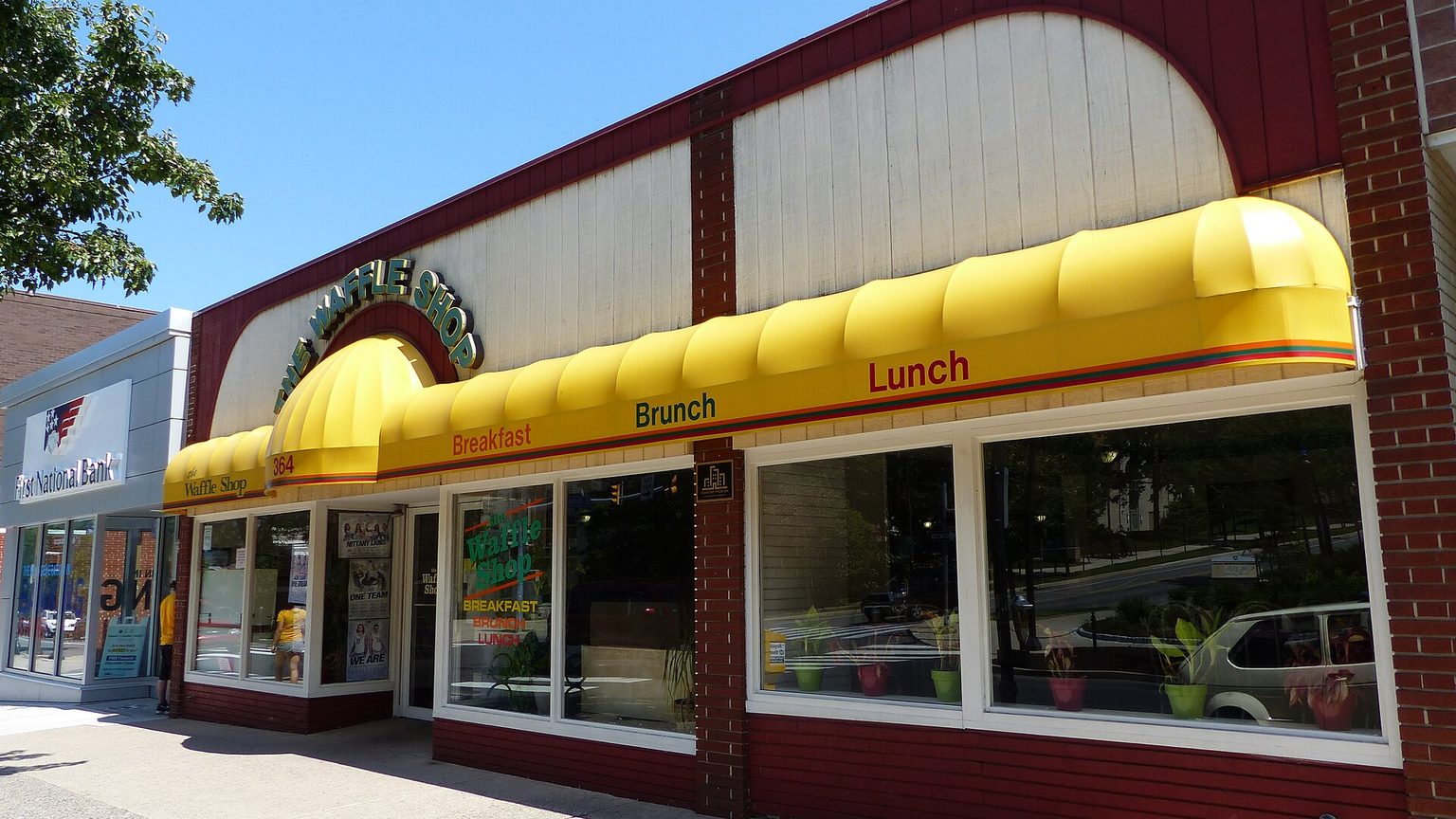 Pedestrians and storefronts along College Avenue in downtown State College, Pennsylvania, across from the Penn State University Park campus.