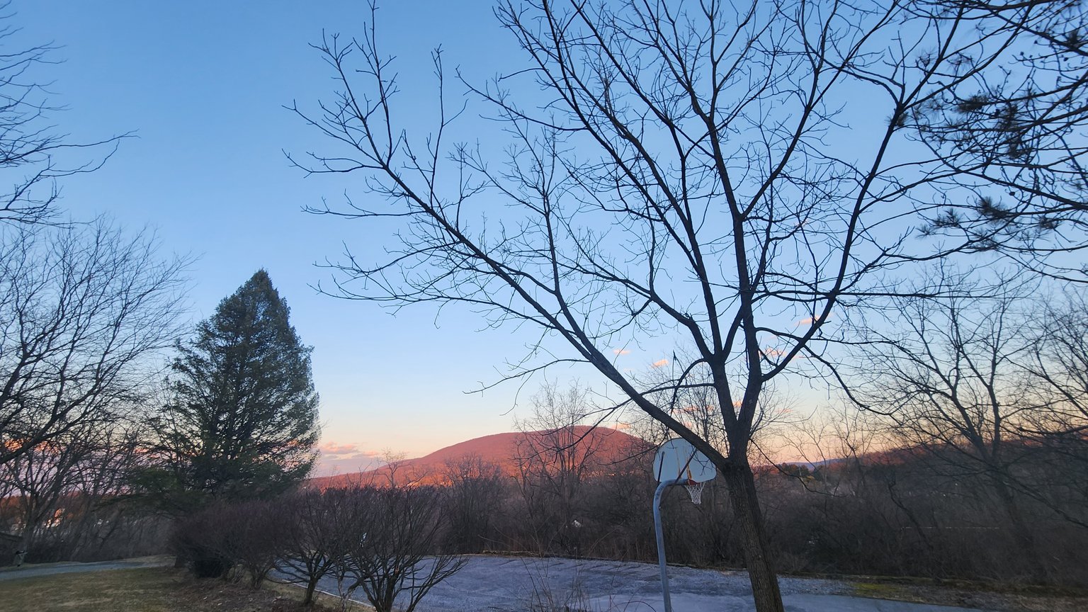 Real photo of Mount Nittany rising above the Nittany Valley near State College, Pennsylvania — the iconic hiking landmark for Penn State students and locals.